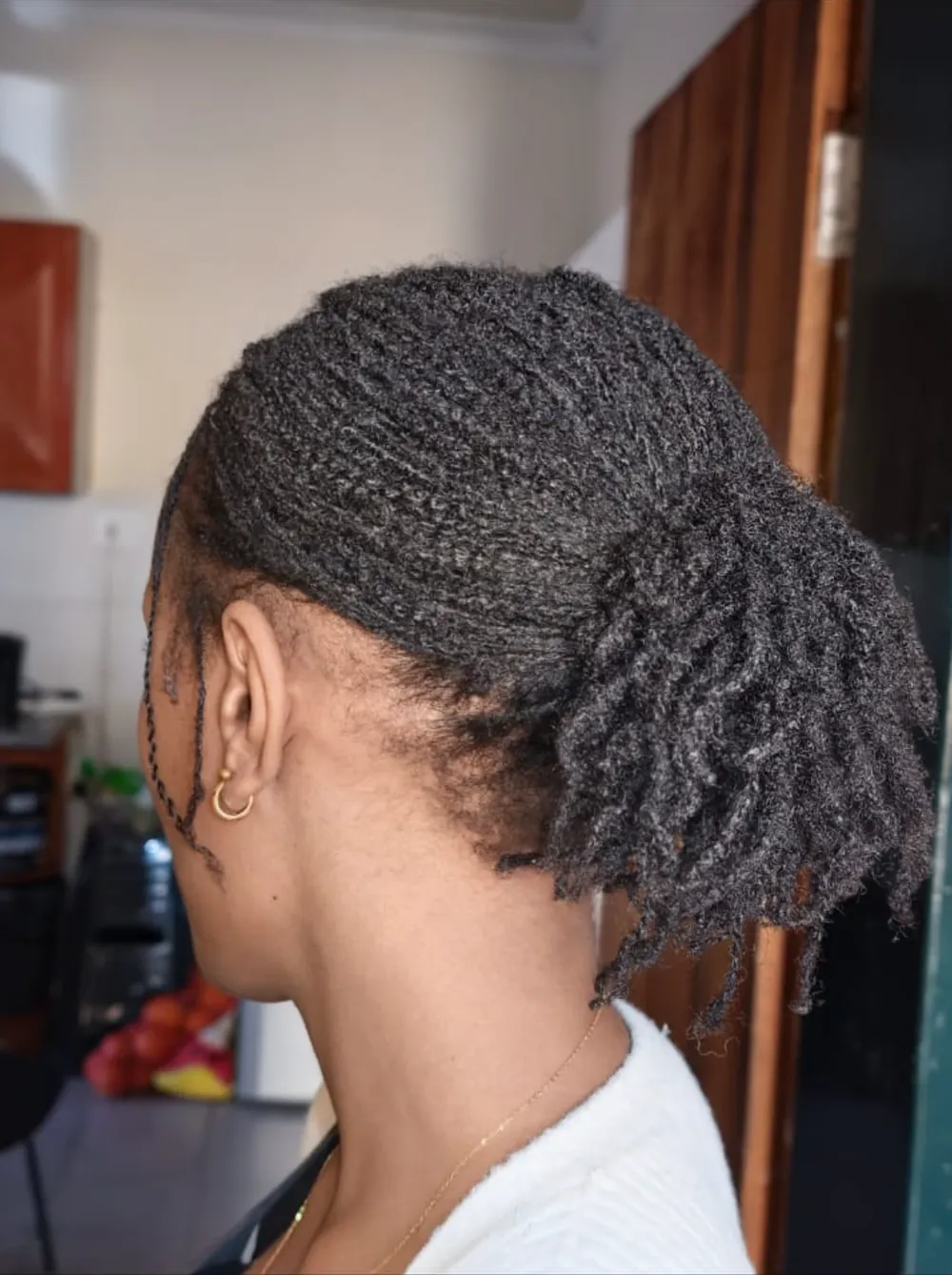 Micro locs styled in a low ponytail